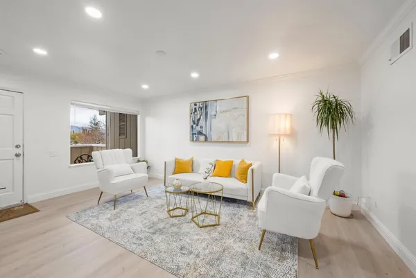 a living room with furniture and a potted plant