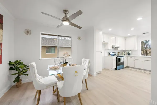a kitchen with a table chairs refrigerator and microwave