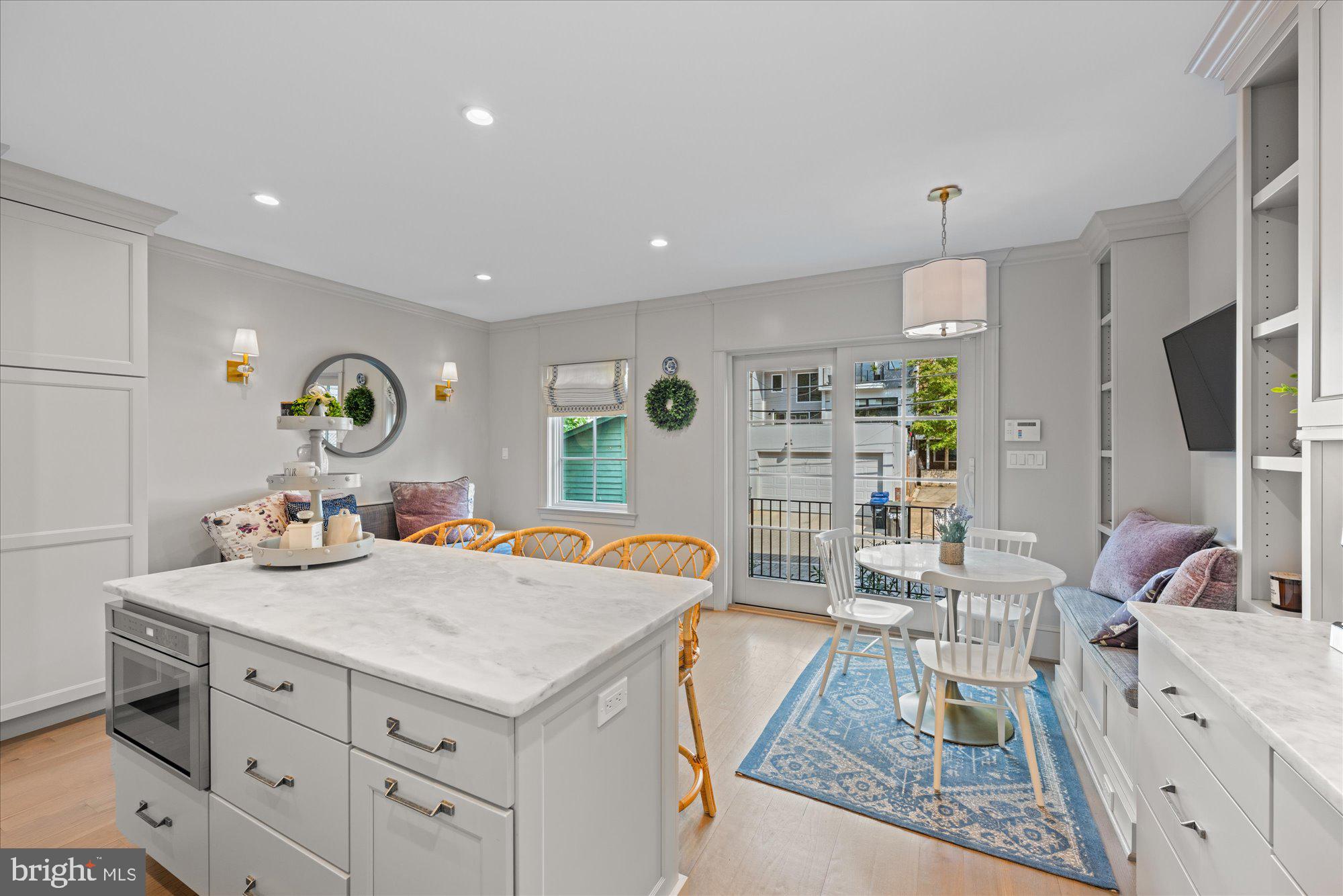 3723 Reservoir Road Northwest Washington, DC 20007 - Photo 12 of 45 a living room with kitchen island furniture and a flat screen tv