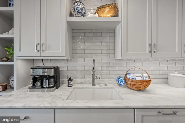 a kitchen with a stove and a white cabinets