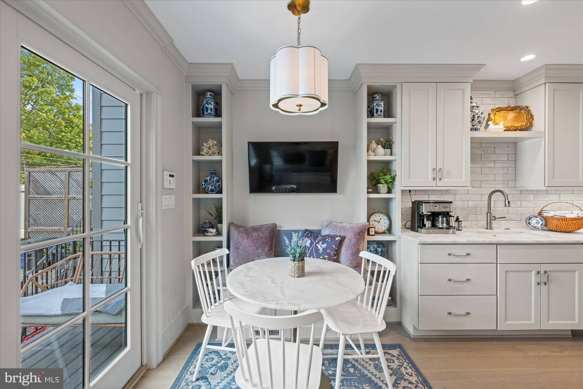 3723 Reservoir Road Northwest Washington, DC 20007 - Photo 13 of 45 a dining room with wooden floor a chandelier a wooden table and chairs