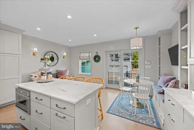 a living room with kitchen island furniture and a flat screen tv