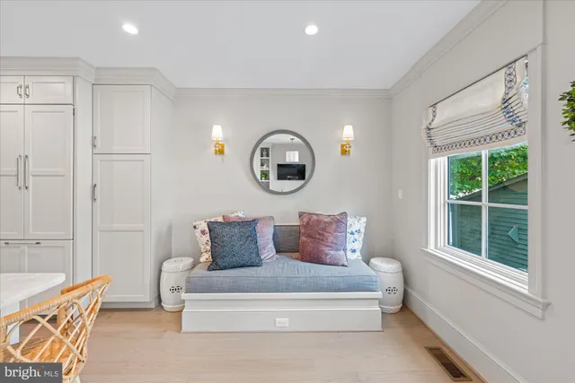 a white bench sitting in front of a window