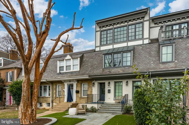 a living room with furniture a flat screen tv and a large window