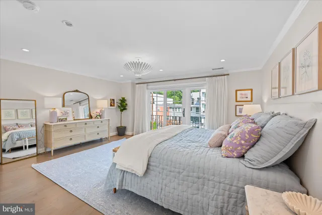 a bedroom with a large bed and a large window