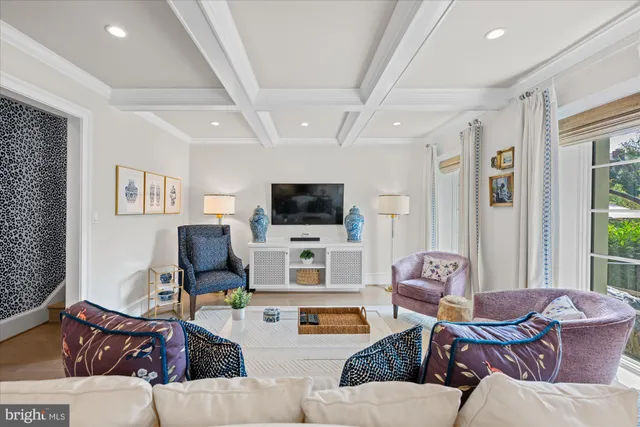 a living room with furniture a flat screen tv and a large window