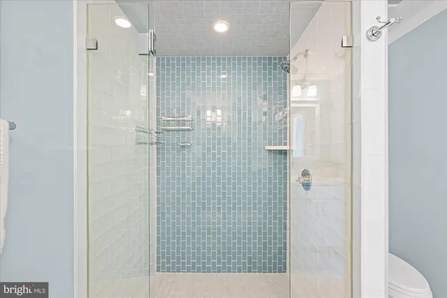 a view of a kitchen with refrigerator and windows