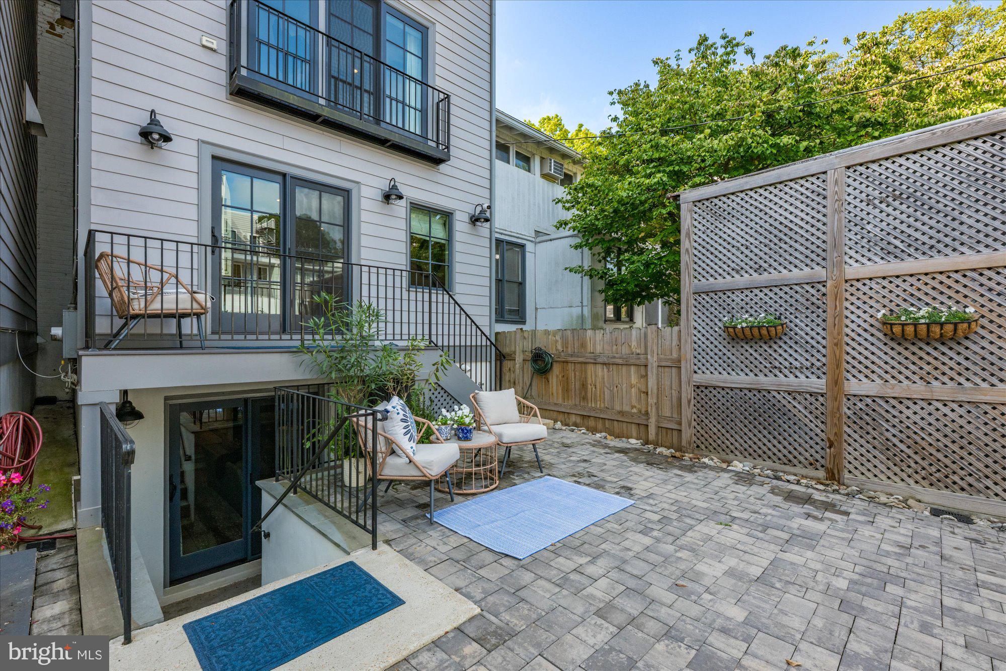 3723 Reservoir Road Northwest Washington, DC 20007 - Photo 39 of 45 a view of a patio with table and chairs with wooden fence and plants