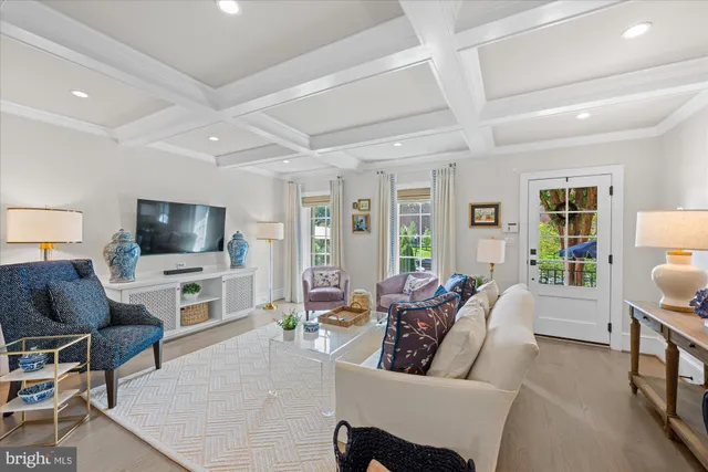 a living room with furniture a flat screen tv and a large window
