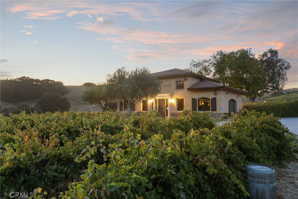 3000 Oakdale Road Paso Robles, CA 93446 - Photo 23 of 26 a view of a house with a yard and table and chairs under an umbrella