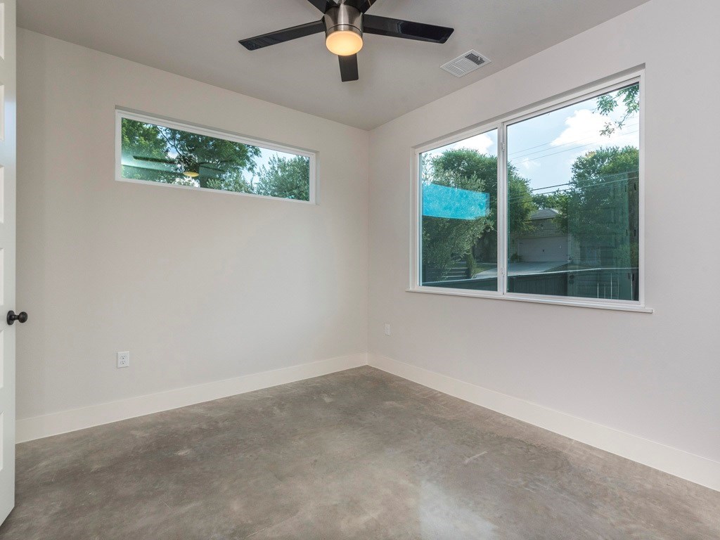 1182 Ridgeway Drive, Unit A Austin, TX 78702 - Photo 12 of 27 a view of empty room with window and ceiling fan