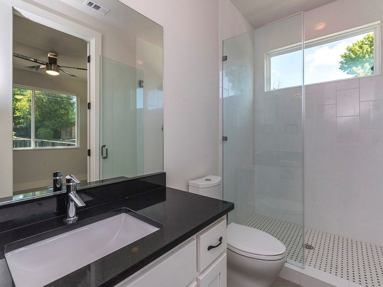 1182 Ridgeway Drive, Unit A Austin, TX 78702 - Photo 20 of 27 a bathroom with a granite countertop sink toilet and shower