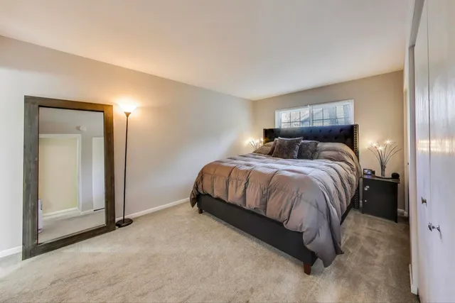 a bedroom with a bed and a mirror