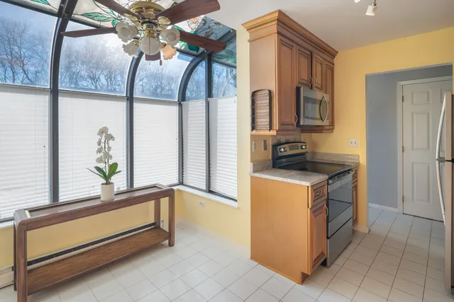 a kitchen with a refrigerator and a stove