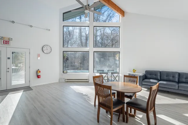 a view of a dining room with furniture and a large window