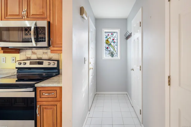 a view of a kitchen that has a stove and a microwave