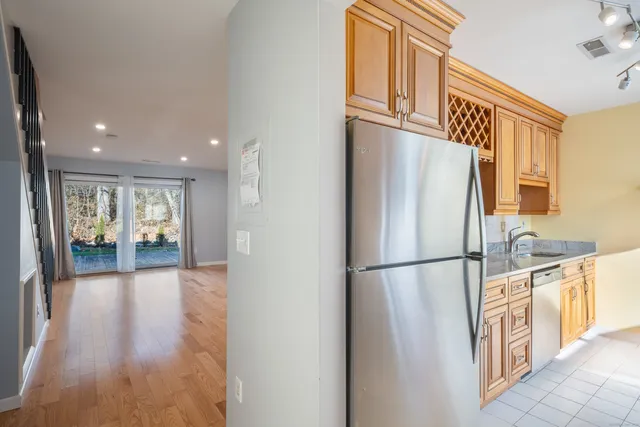 a view of a hallway with wooden floor and windows