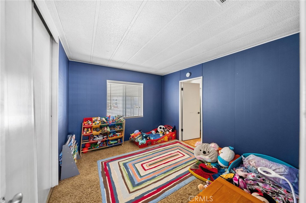 26311 Jackson Avenue, Unit 35 Murrieta, CA 92563 - Photo 19 of 41 a bed room with furniture and a window