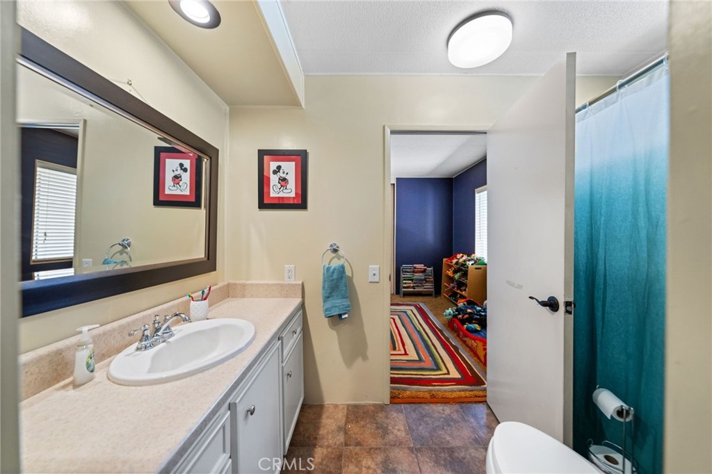 26311 Jackson Avenue, Unit 35 Murrieta, CA 92563 - Photo 21 of 41 a bathroom with a sink a toilet and a mirror