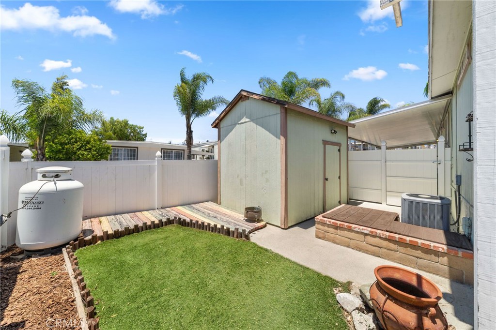 26311 Jackson Avenue, Unit 35 Murrieta, CA 92563 - Photo 26 of 41 a backyard of a house with table and chairs