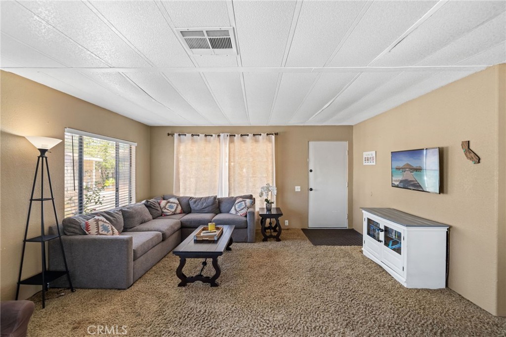 26311 Jackson Avenue, Unit 35 Murrieta, CA 92563 - Photo 5 of 41 a living room with furniture and a large window
