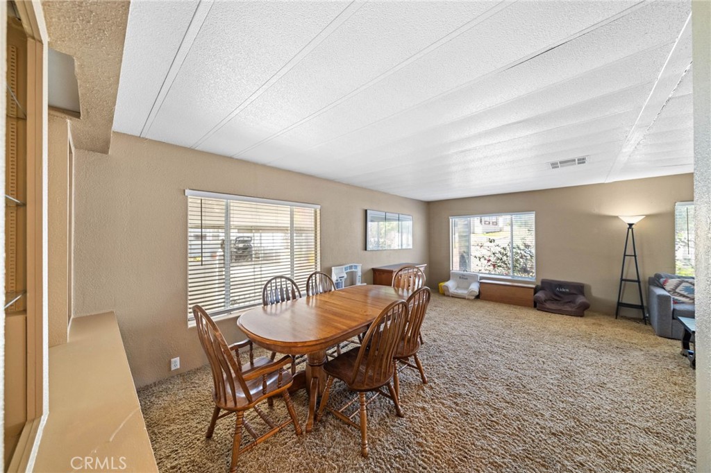 26311 Jackson Avenue, Unit 35 Murrieta, CA 92563 - Photo 8 of 41 a view of a dining room with furniture and a window