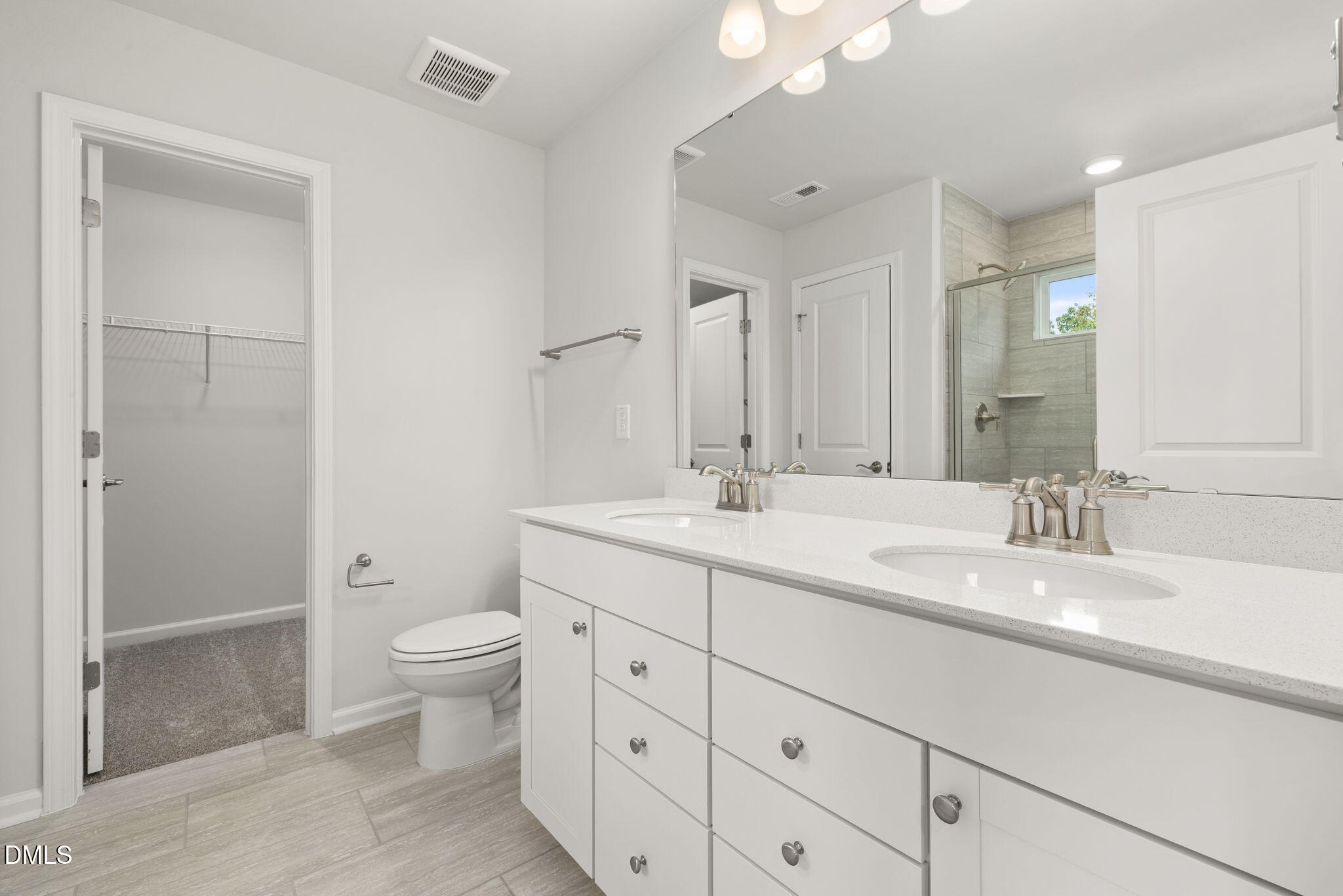 617 Ben Ledi Court Raleigh, NC 27603 - Photo 12 of 33 a bathroom with a double vanity sink toilet and shower