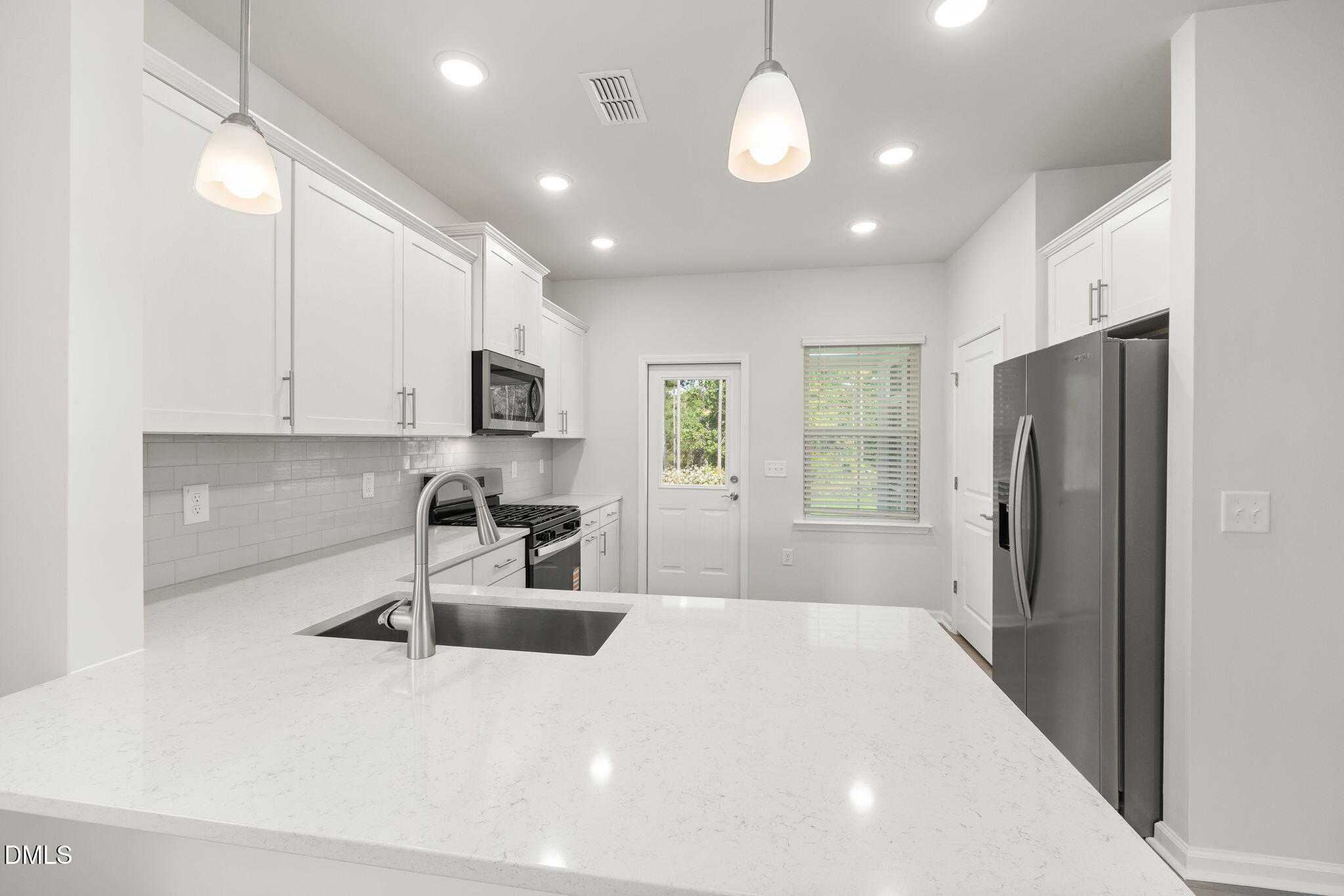 617 Ben Ledi Court Raleigh, NC 27603 - Photo 4 of 33 a kitchen with stainless steel appliances a refrigerator sink and microwave