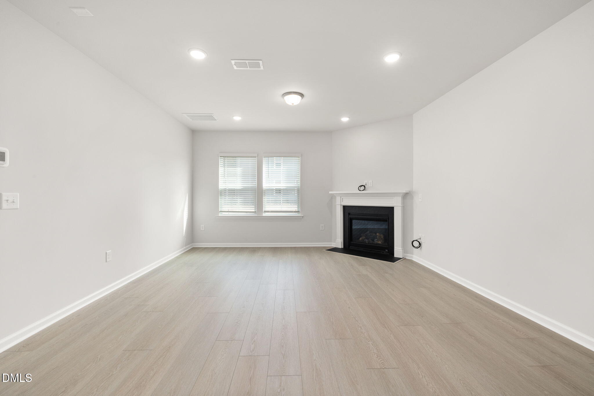 617 Ben Ledi Court Raleigh, NC 27603 - Photo 8 of 33 an empty room with windows and fireplace