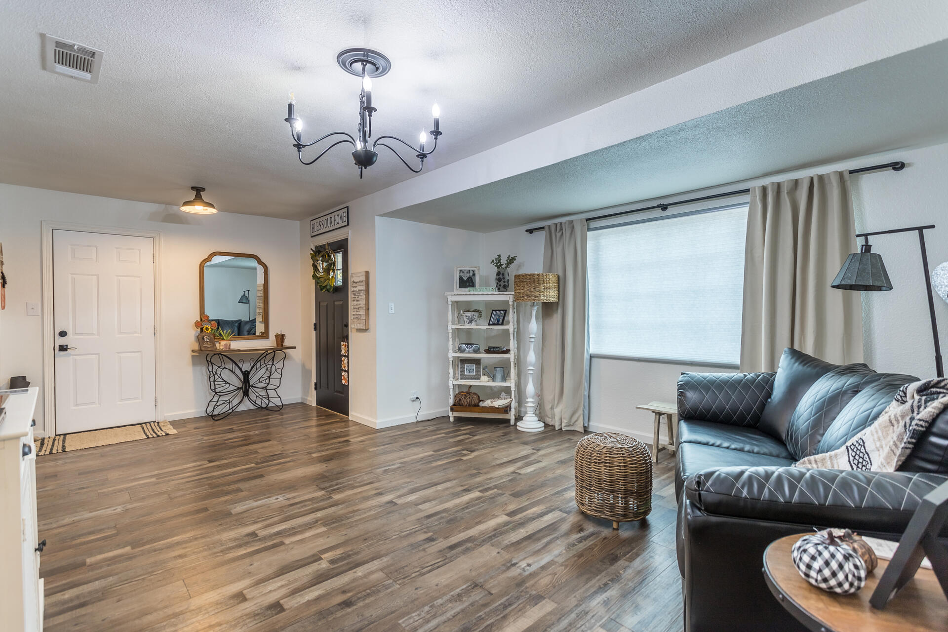 1115 Layton Road Redding, CA 96002 - Photo 7 of 26 a living room with furniture and a chandelier