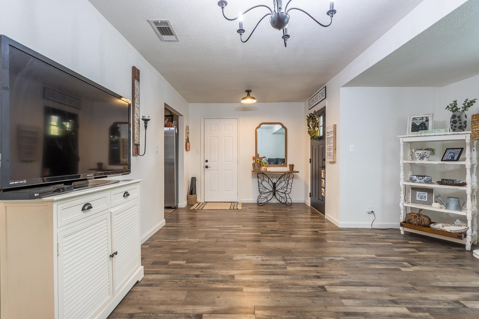 1115 Layton Road Redding, CA 96002 - Photo 8 of 26 a view of a living room and kitchen with furniture wooden floor and a flat screen tv