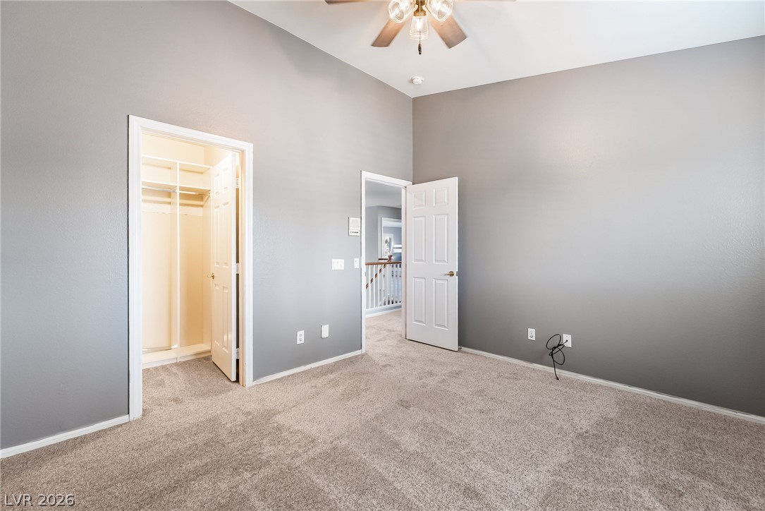 261 Timber Hollow Street Henderson, NV 89012 - Photo 39 of 51 Ample closet space complements this well-lit bedroom, offering practical design.
