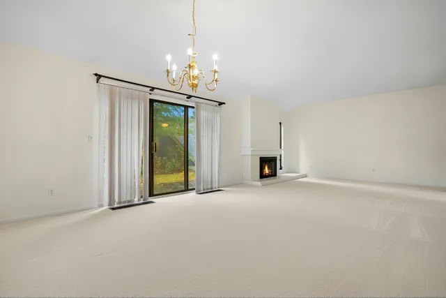 a view of an empty room with a fireplace