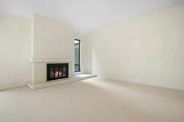 an empty room with a ceiling fan and bathroom