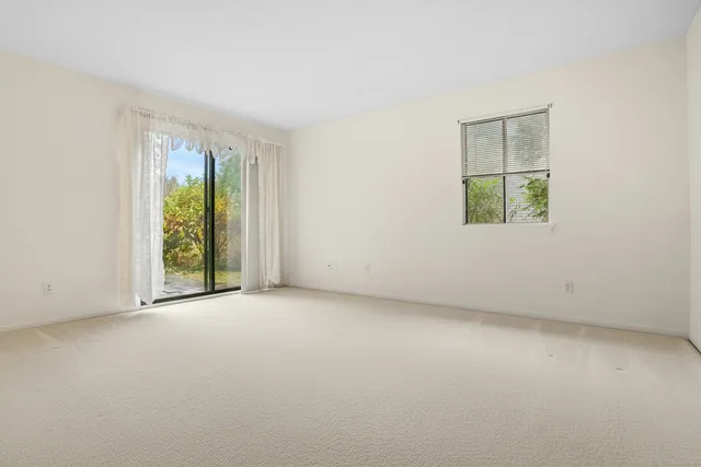 a bedroom with a bed and a large mirror