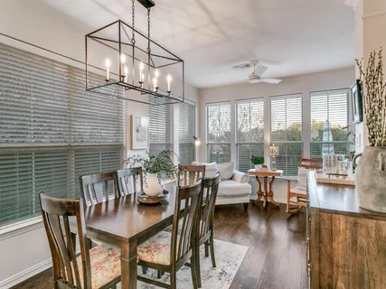 a view of a dining room with furniture wooden floor and chandelier