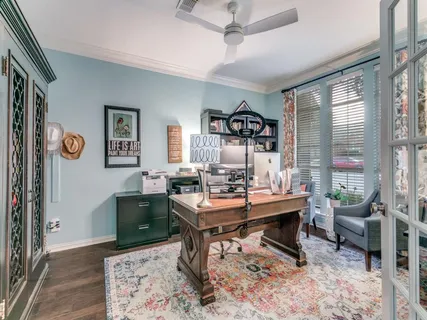a view of a workspace with furniture and a rug