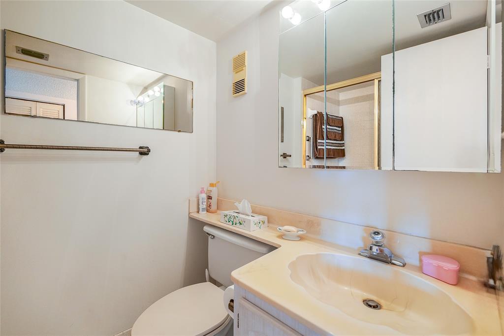 3910 Inverrary Boulevard, Unit 805B Lauderhill, FL 33319 - Photo 13 of 38 a bathroom with a sink toilet and mirror
