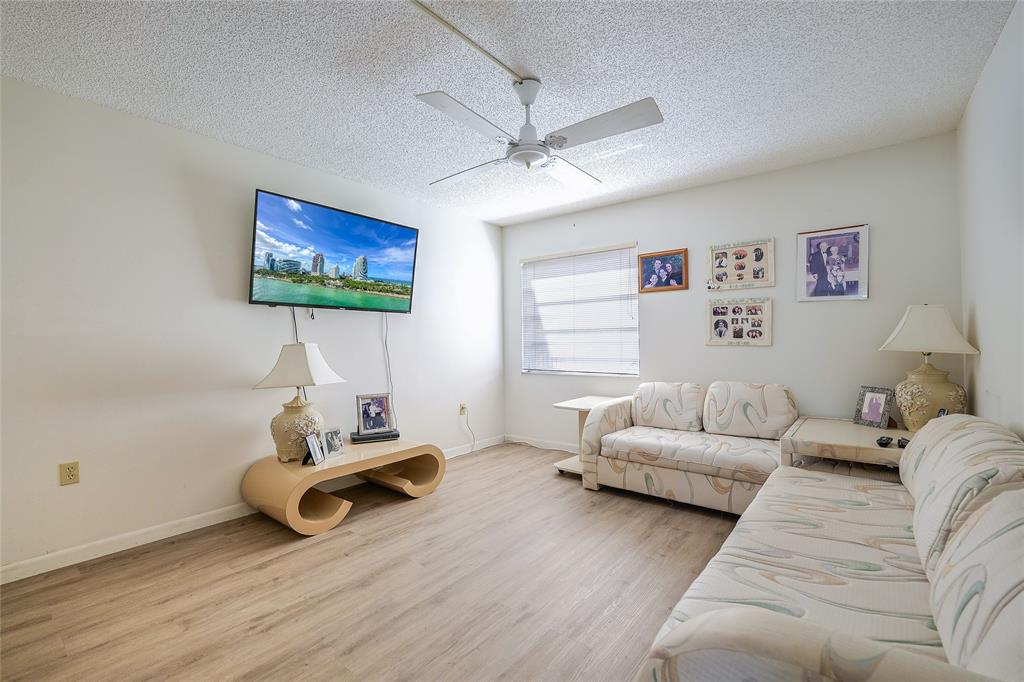 3910 Inverrary Boulevard, Unit 805B Lauderhill, FL 33319 - Photo 17 of 38 a living room with furniture and a flat screen tv