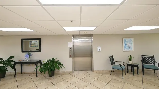 an empty room with cabinet and view of bathroom