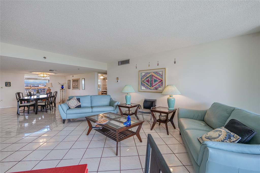 3910 Inverrary Boulevard, Unit 805B Lauderhill, FL 33319 - Photo 4 of 38 a living room with furniture and a dining table with chair