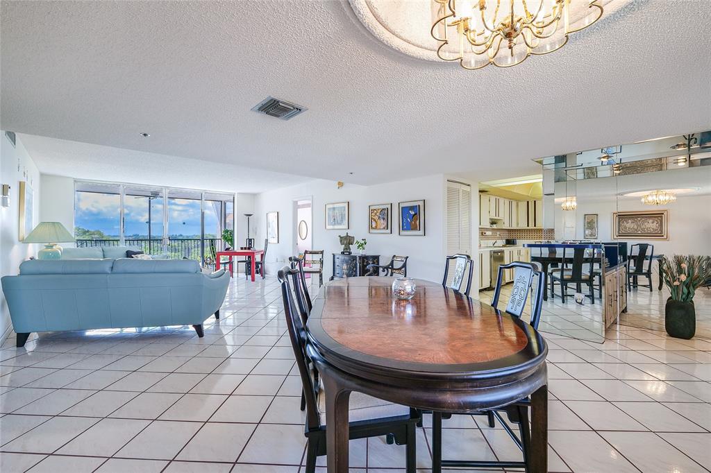 3910 Inverrary Boulevard, Unit 805B Lauderhill, FL 33319 - Photo 6 of 38 a dining room with furniture and a chandelier
