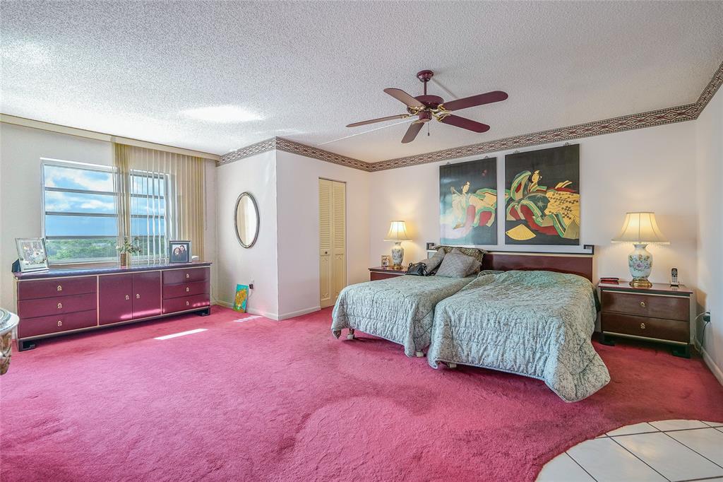 3910 Inverrary Boulevard, Unit 805B Lauderhill, FL 33319 - Photo 10 of 38 a bedroom with a large bed and a window