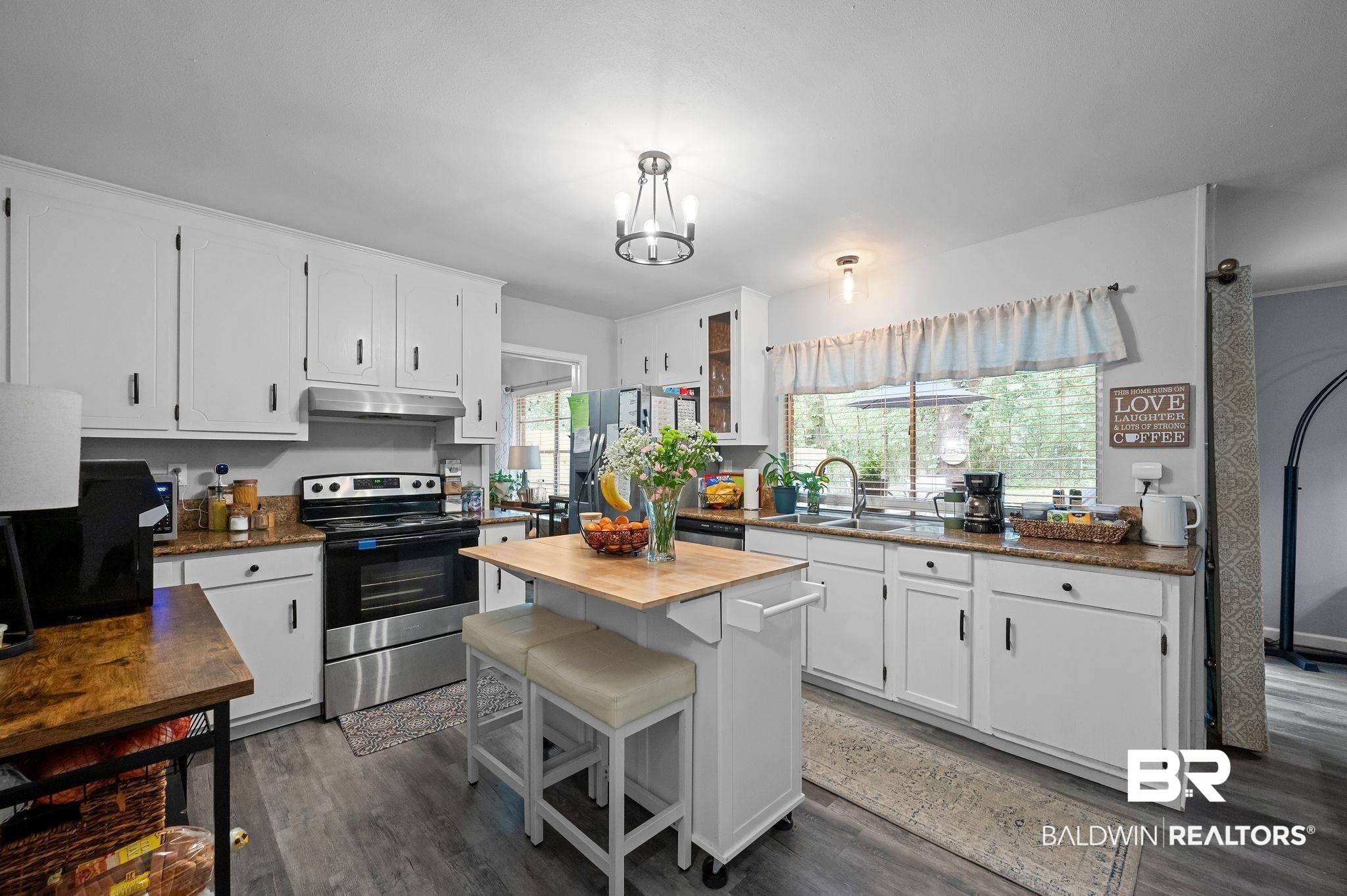 4724 Wicker Way Mobile, AL 36609 - Photo 13 of 36 Kitchen featuring white cabinetry, granite-finish countertops, stainless steel appliances, and wood-finish flooring