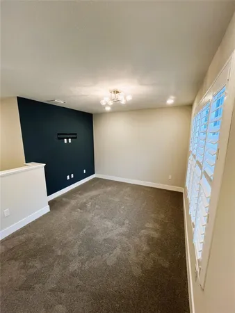 a view of an empty room and a window