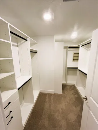 a view of hallway with stairs and wooden floor