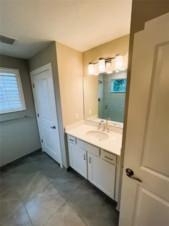 a bathroom with a double vanity sink and mirror