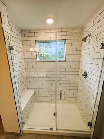 a bathroom with a shower and a sink