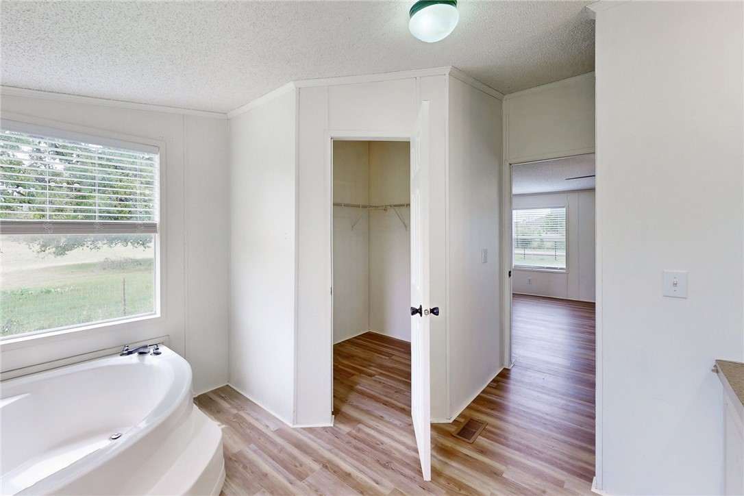 11459 Winstead Lane Calvert, TX 77837 - Photo 24 of 37 a bathroom with a tub shower and sink