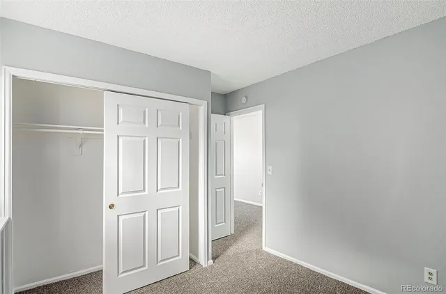 an empty room with closet area